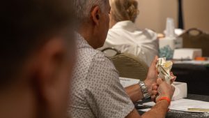 An attendee places a zygomatic implant in a dry hands-on model.